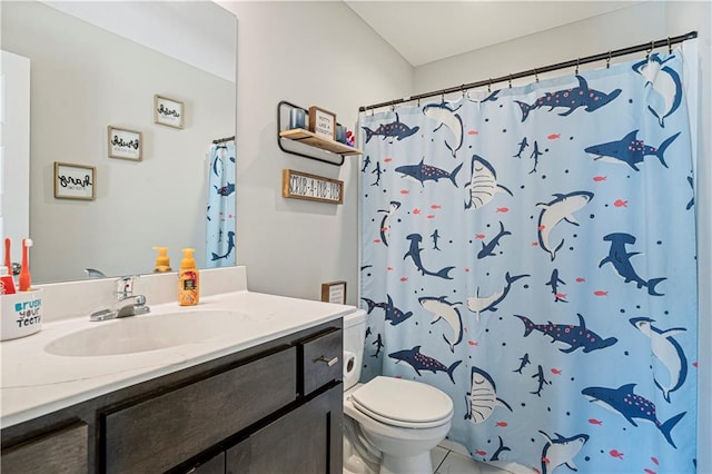 bathroom featuring tile patterned floors, vanity, toilet, and walk in shower