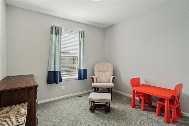 living area featuring carpet floors