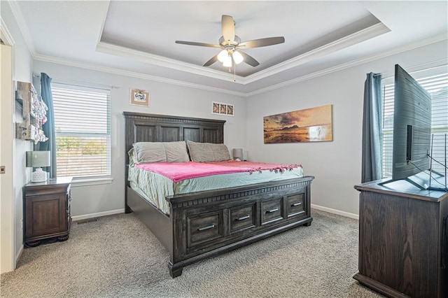 bedroom featuring a raised ceiling, ceiling fan, light colored carpet, and ornamental molding