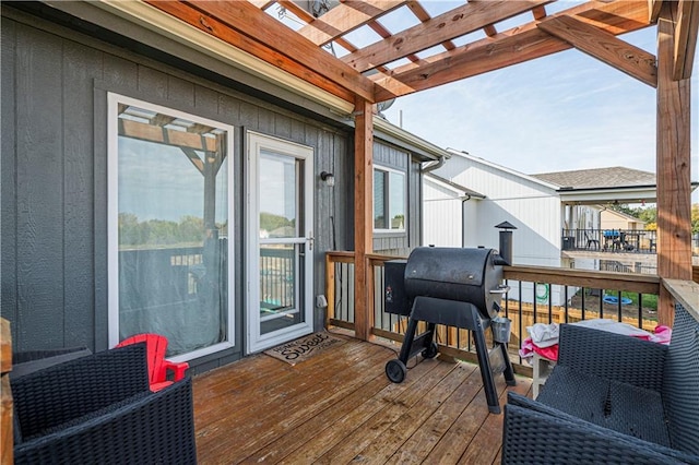 deck with a pergola and area for grilling