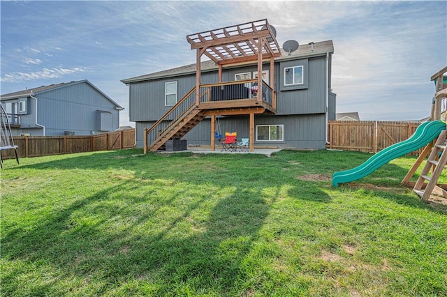 back of property with a playground, a patio area, a yard, and a trampoline