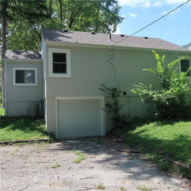 view of side of home featuring a garage