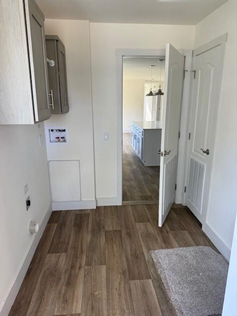 clothes washing area with washer hookup, an inviting chandelier, and dark wood-type flooring