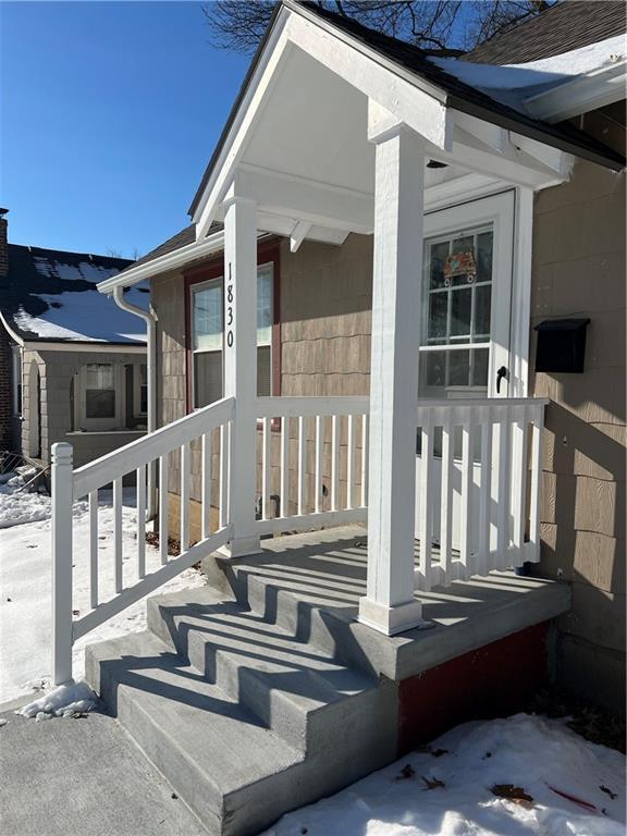 view of snow covered property entrance