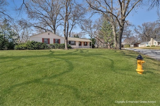 ranch-style home with a front lawn