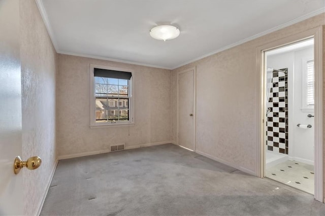 carpeted spare room with visible vents, plenty of natural light, baseboards, and crown molding