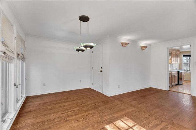 unfurnished room featuring baseboards and light wood finished floors