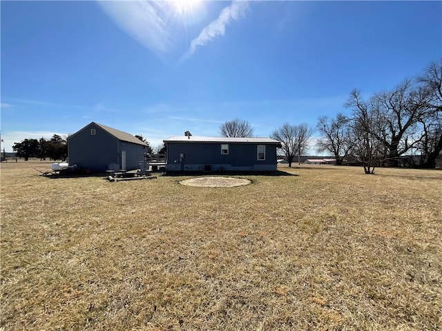 rear view of house with a yard