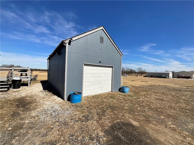 detached garage with dirt driveway