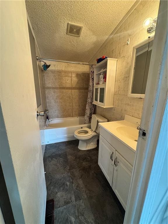 full bathroom featuring visible vents, toilet, a textured ceiling, vanity, and tile walls