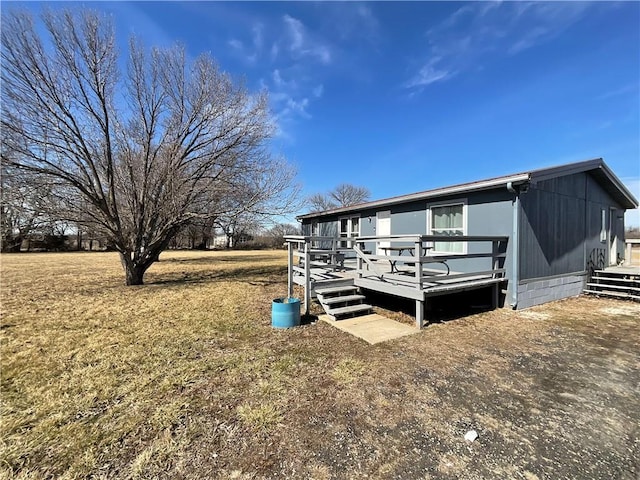 rear view of property featuring a wooden deck