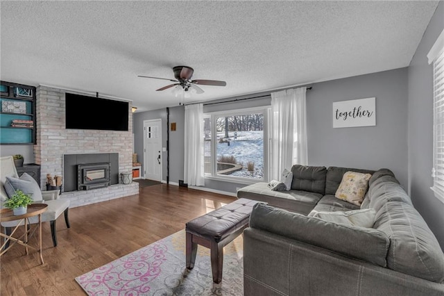 living room with wood-type flooring, a textured ceiling, and ceiling fan