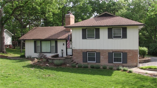 tri-level home with a front yard