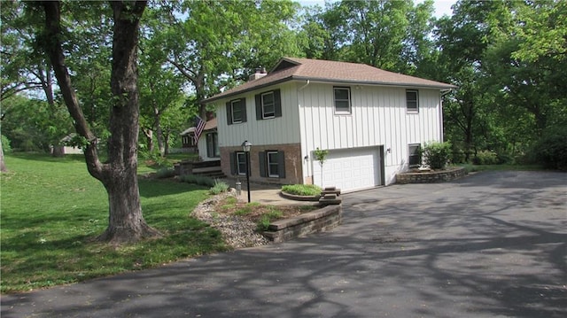 view of front of house with a garage and a front lawn