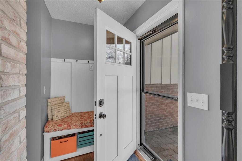 mudroom with a textured ceiling