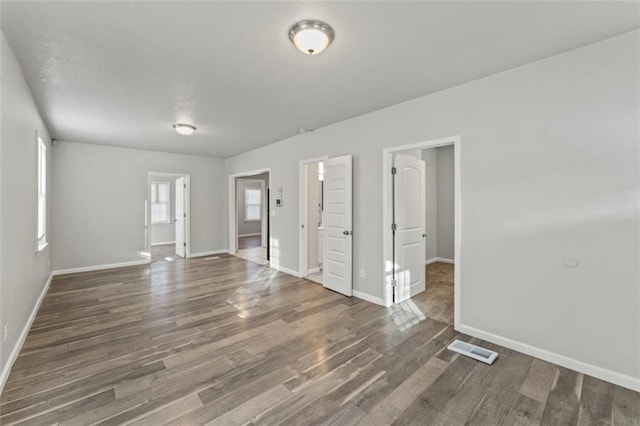 spare room featuring dark wood-type flooring