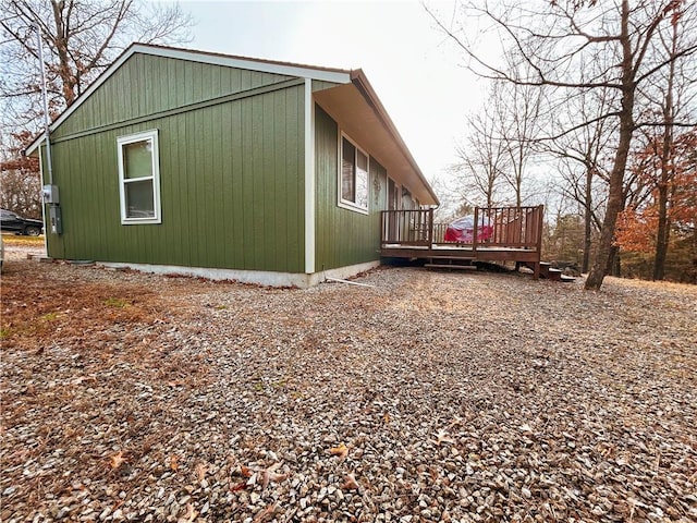 view of property exterior featuring a wooden deck