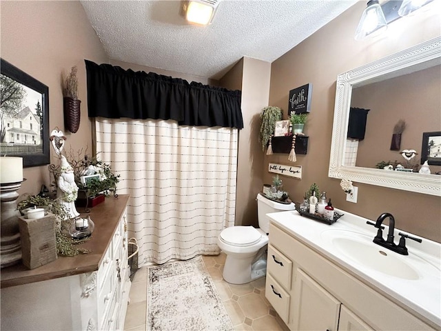 bathroom featuring vanity, toilet, tile patterned flooring, and a textured ceiling