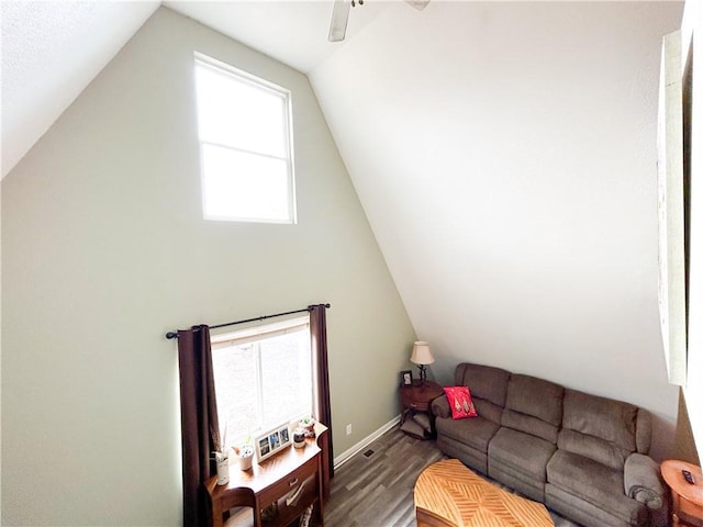 living room featuring hardwood / wood-style flooring, ceiling fan, and lofted ceiling