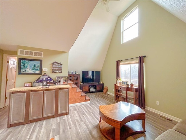 interior space with ceiling fan, light wood-type flooring, and a wealth of natural light