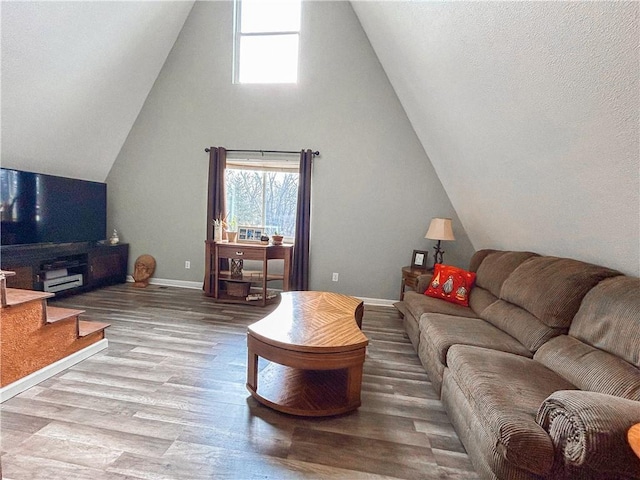 living room featuring vaulted ceiling and light wood-type flooring