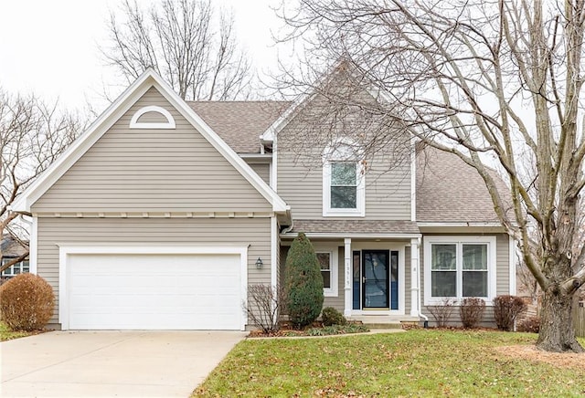 view of front of property with a garage and a front yard