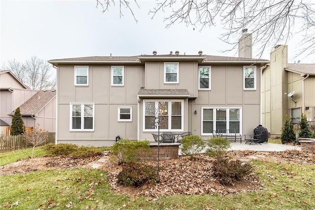 rear view of property with a yard and a patio area