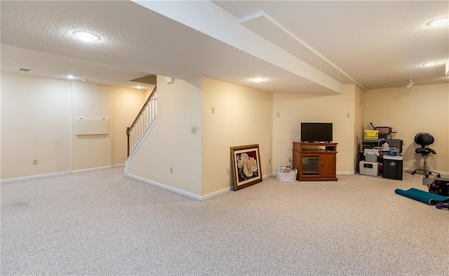 basement featuring carpet floors and a textured ceiling