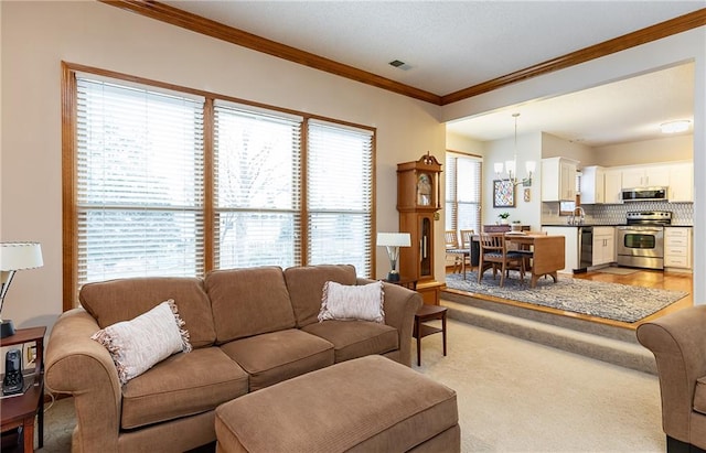 carpeted living room featuring an inviting chandelier and crown molding