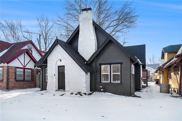 snow covered rear of property with central AC