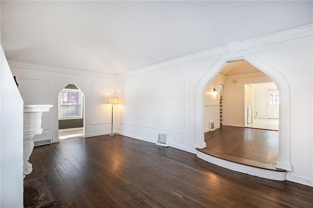 unfurnished living room featuring vaulted ceiling and dark hardwood / wood-style floors