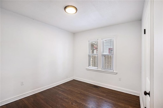 spare room featuring dark hardwood / wood-style floors