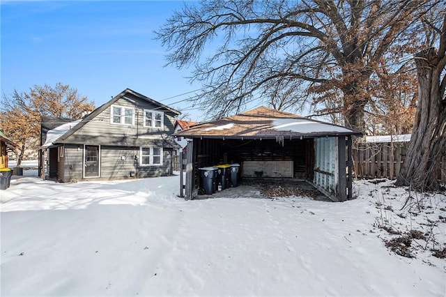 snow covered house with an outbuilding