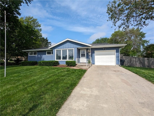 ranch-style house with a front yard and a garage