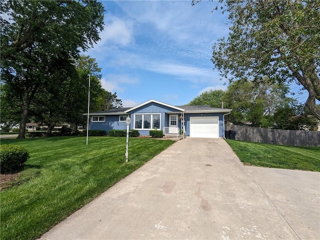 single story home featuring a front lawn and a garage