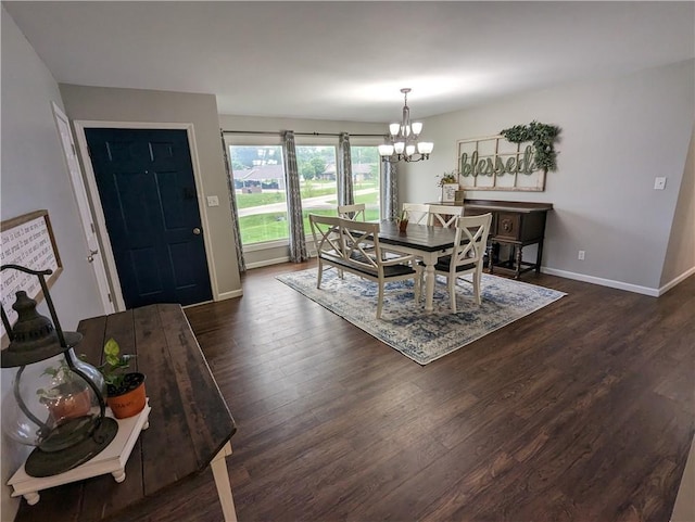 dining room with dark wood-type flooring and a notable chandelier