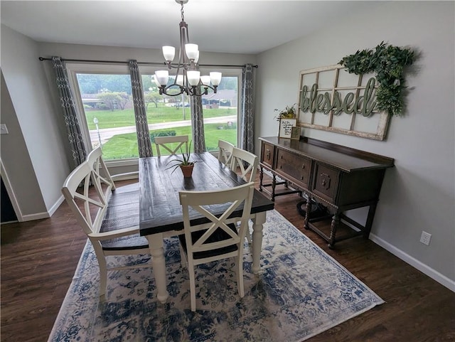 dining space with dark hardwood / wood-style floors and a chandelier