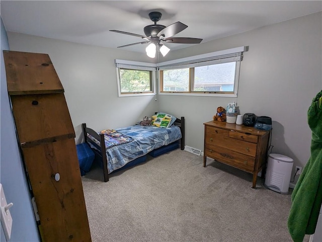 bedroom with light carpet and ceiling fan