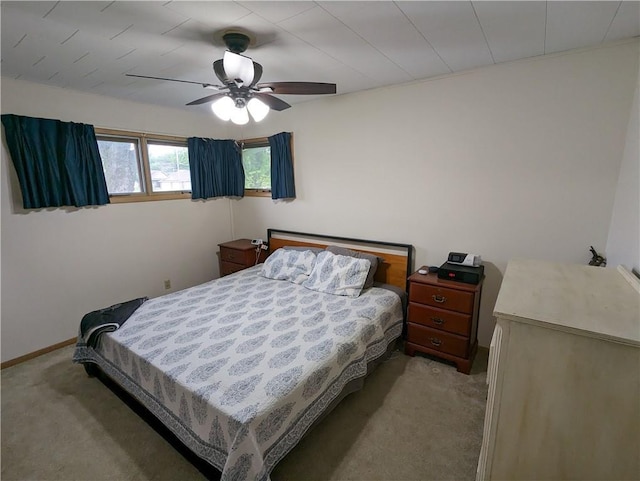 bedroom with ceiling fan and light carpet