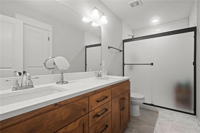 bathroom with toilet, walk in shower, and vanity