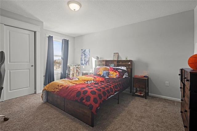 bedroom featuring carpet and a textured ceiling