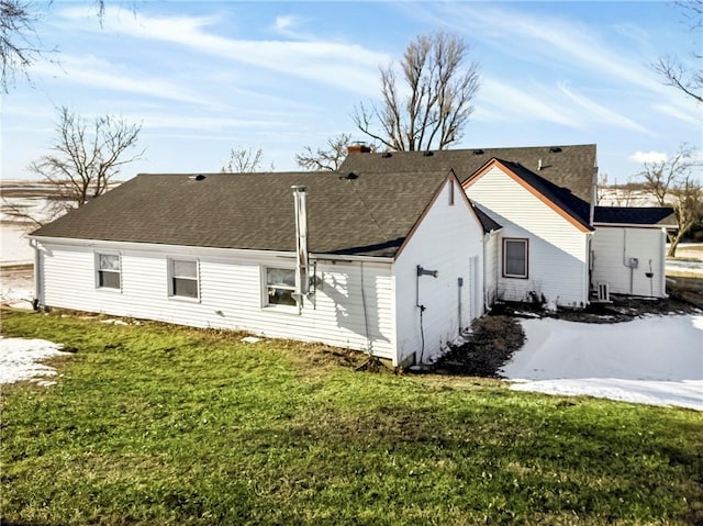 rear view of property with a yard