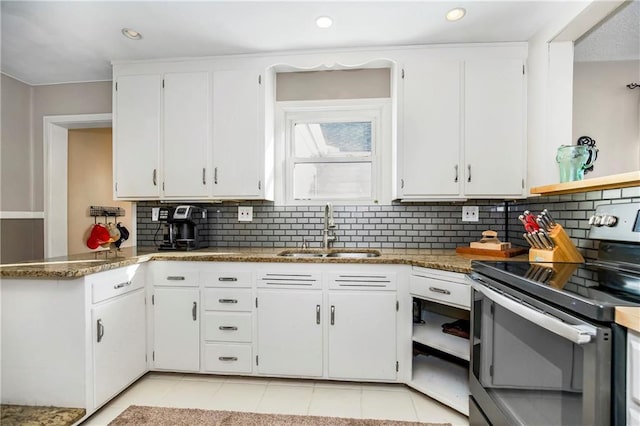 kitchen featuring light tile patterned floors, sink, white cabinets, and stainless steel electric range oven