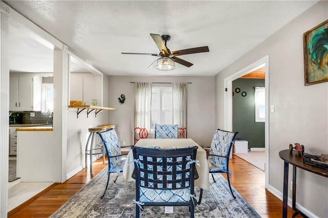 dining space featuring light hardwood / wood-style floors and ceiling fan