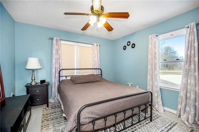 bedroom featuring ceiling fan and a textured ceiling