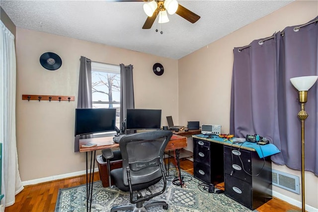 office with ceiling fan, hardwood / wood-style floors, and a textured ceiling