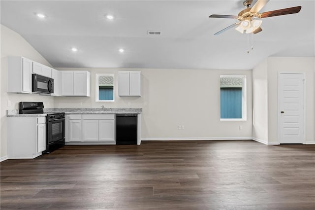 kitchen featuring black appliances, white cabinets, and dark wood-type flooring