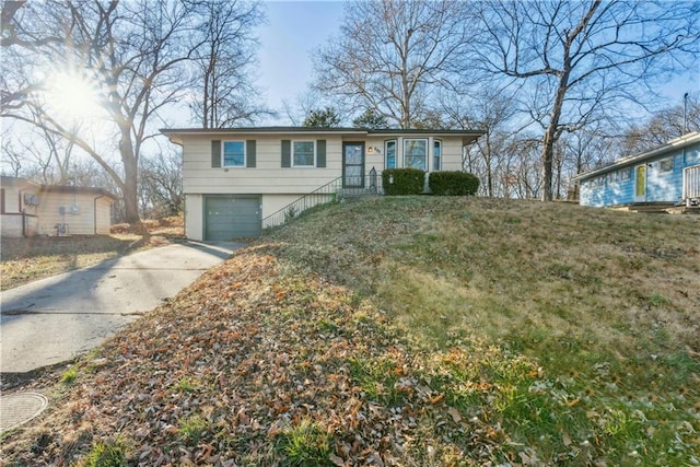 view of front facade with a garage and a front lawn