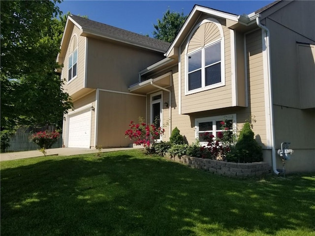 view of front facade with a front yard and a garage