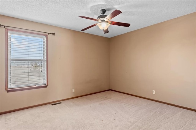 carpeted empty room with a textured ceiling and ceiling fan